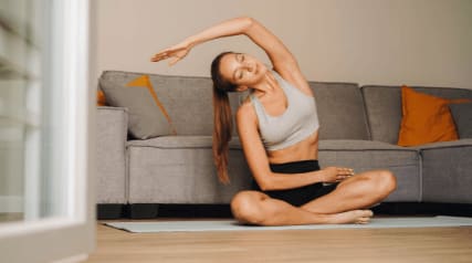 a woman doing a yoga pose on the floor of a living room at Scottsdale Hayden Townhomes, Scottsdale, AZ, 85257