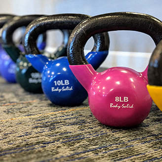a row of dumbbells are lined up next to some weights at Upscale Living at the Grand off 45th, Fargo, ND, 58104