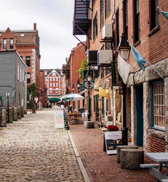 a cobblestone street in a small town with brick buildings