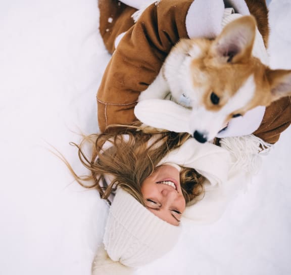 a woman lying on the ground with her dog