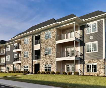 an exterior view of an apartment building on a sunny day