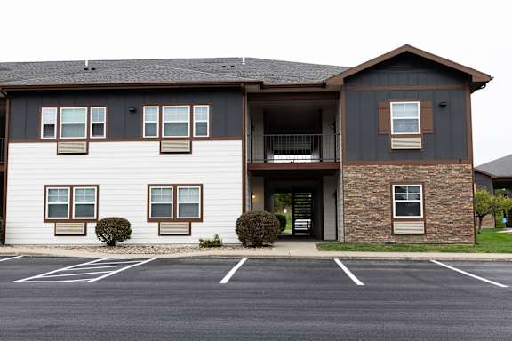 A building with a parking lot in front of it.