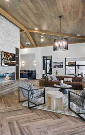 A modern living room with a fireplace and a large window.