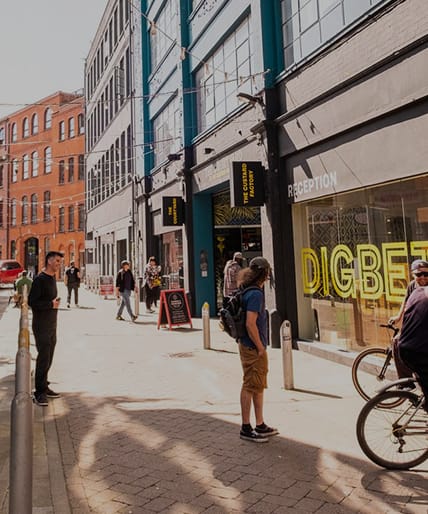 people standing on a sidewalk in front of a building