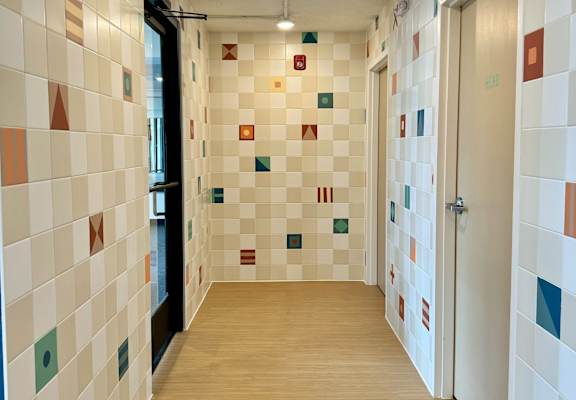 a hallway with a wood floor and tiles on the walls and a door at The Teale Navy Yard, North Charleston, SC