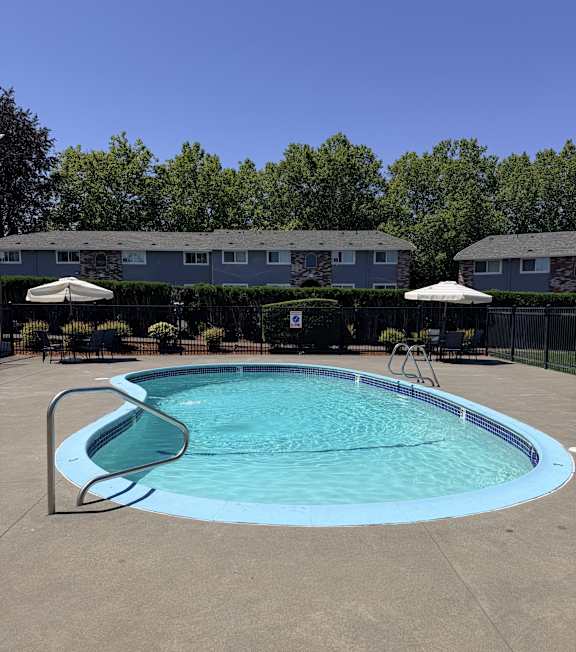 A small pool with a metal fence around it.