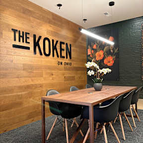 A room with a wooden table and chairs and a sign that says "Kroken on Ohio".