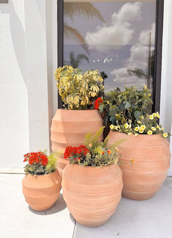 A group of pots with flowers in them. at The Teale Siesta Lago in Kissimmee, FL, 34746