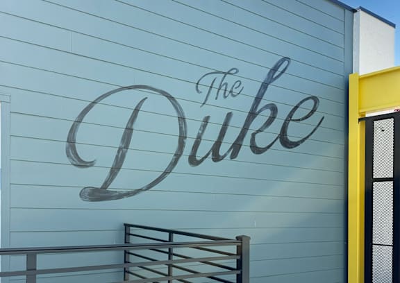 A building with a sign that says "The Duke" on it.