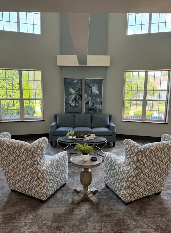 a view from above of a living room with couches and a table and windows