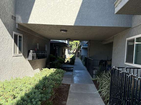 A concrete building with a small window and a door.