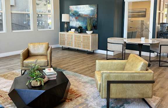 A modern living room with a grey sofa, wooden coffee table, and a large floor lamp.
