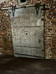 A wall with a grid pattern and a door on the left side.