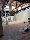 A view of a wooden beam and a pipe in a building.