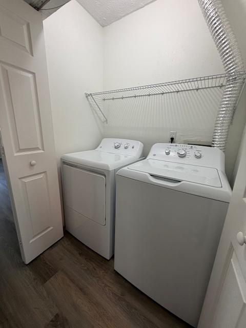 A small laundry room with a washer and dryer.