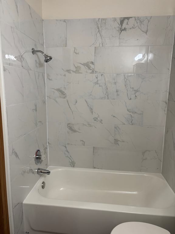 Remodeled bathroom vanity with mirror and white finishes at Muirfield Apartments.