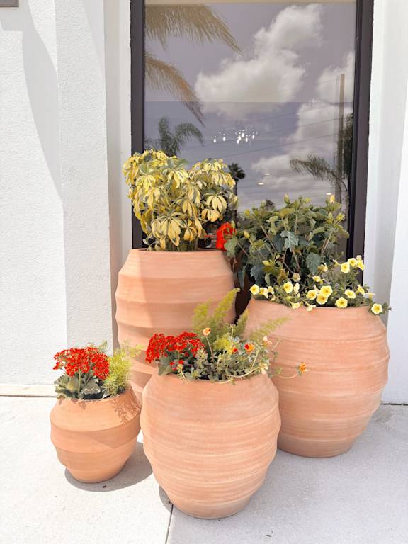 A group of pots with flowers in them.