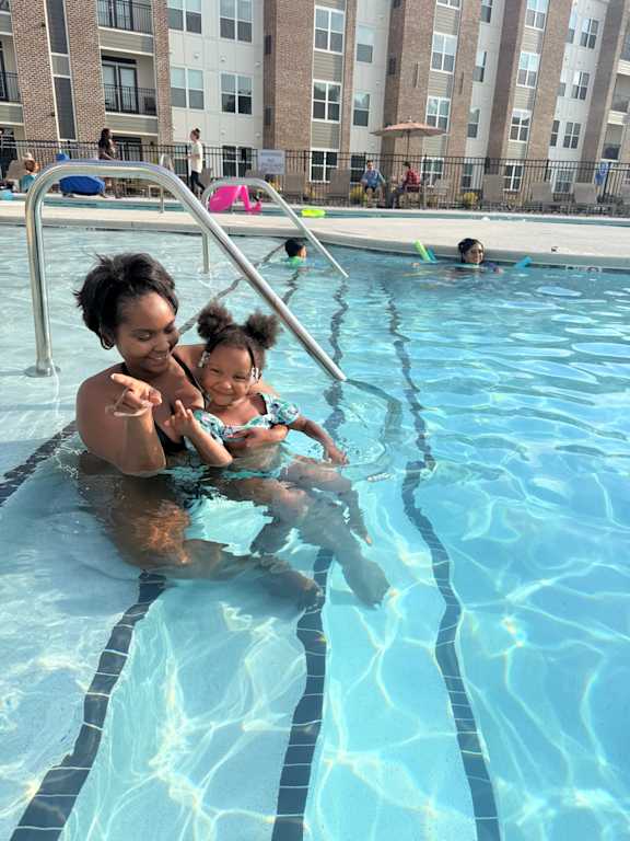A man and a woman are swimming in a pool.