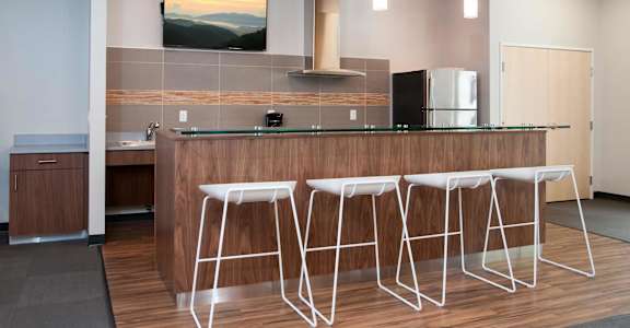 a kitchen with a bar and stools