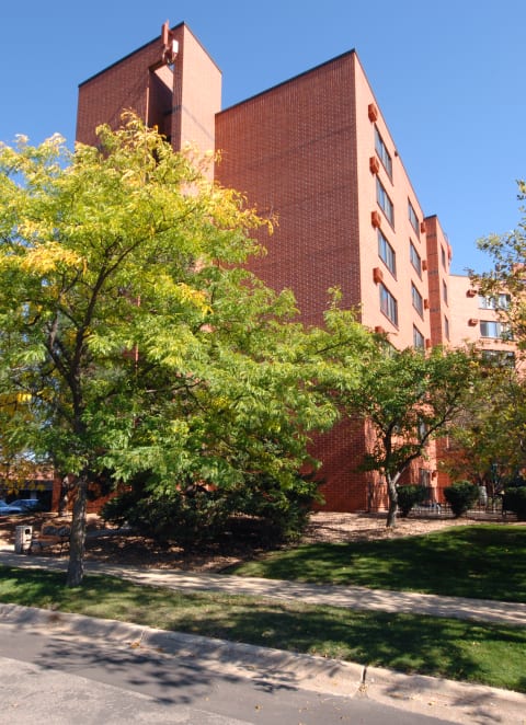 a large brick building with trees in front of it