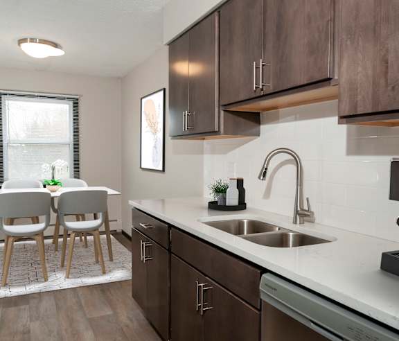 A modern kitchen with a dining table and chairs.