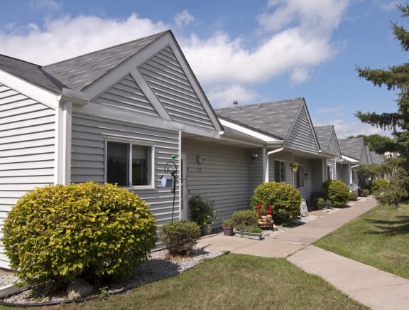 a row of houses with a lawn in front of them