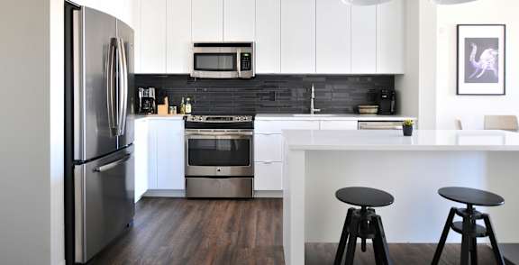 A kitchen with wooden cabinets and a white refrigerator.