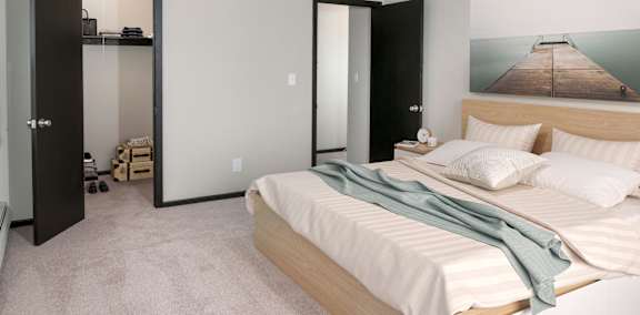 A bedroom with a bed, a dresser, and a painting on the wall.