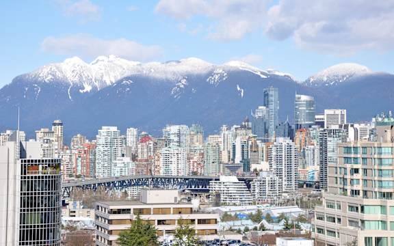 a view of the city with mountains in the background