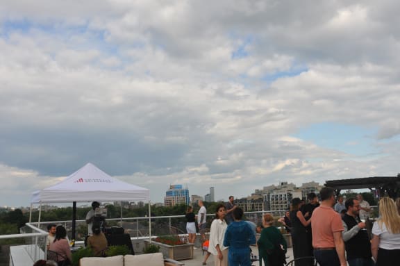 a crowd of people at a party on the roof of a building