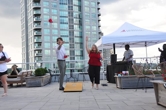 a group of people playing frisbee on a rooftop terrace