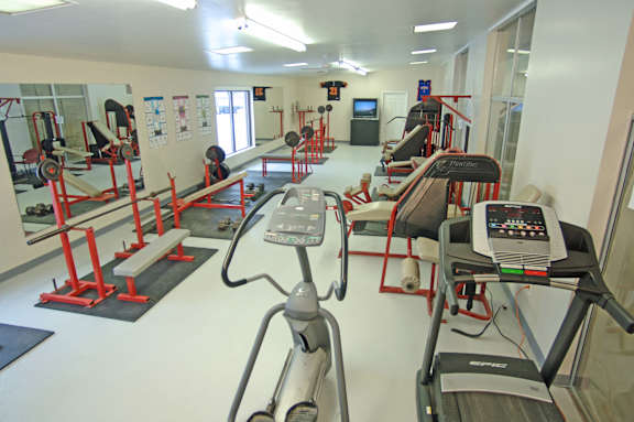 A gym with treadmills, exercise bikes, and other equipment.