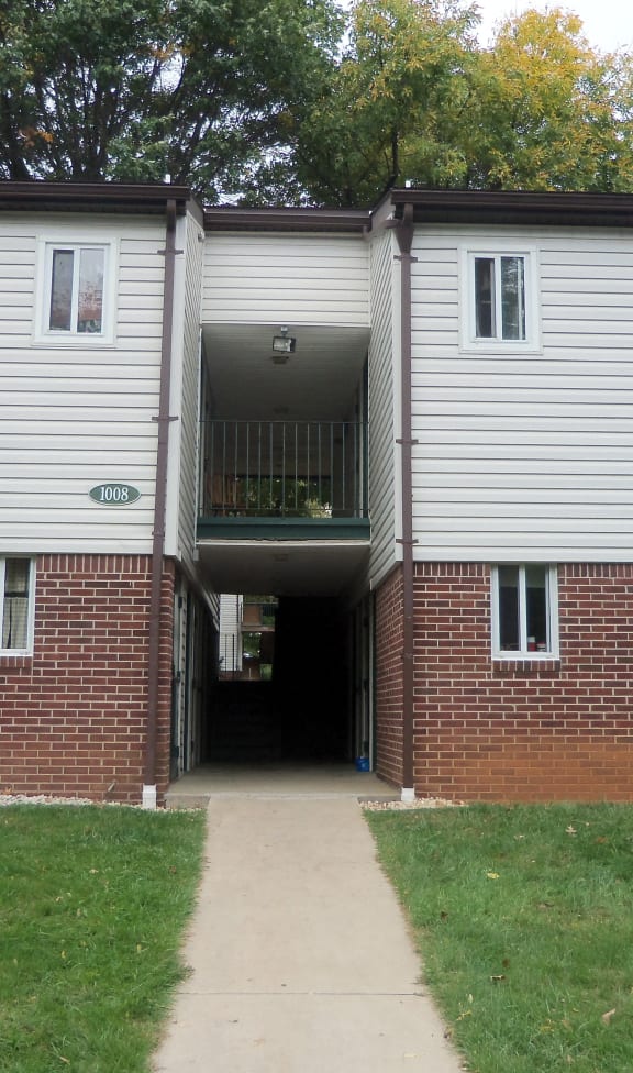 the entrance to an apartment building with a walkway