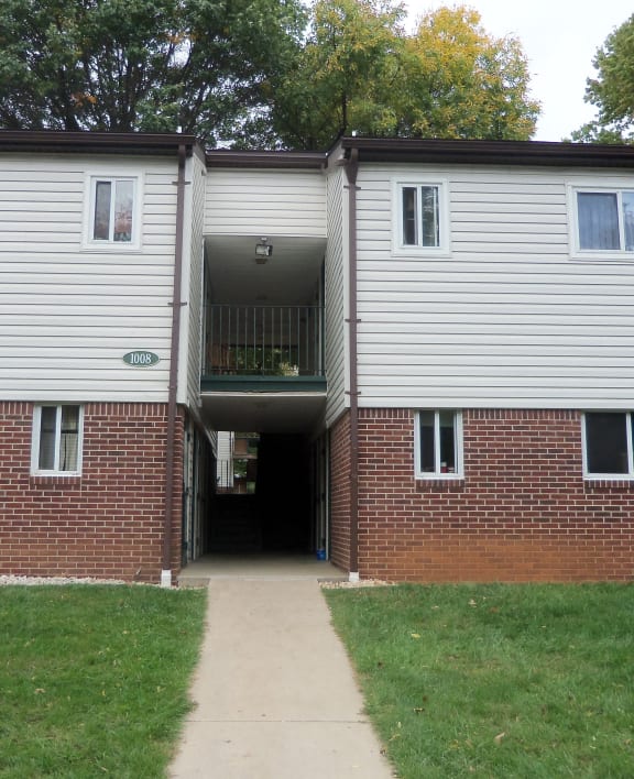the entrance to an apartment building with a walkway