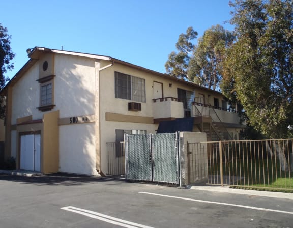 an apartment building with a fence and a gate