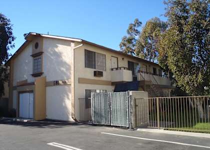 an apartment building with a fence and a gate