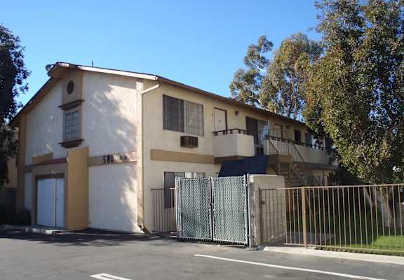 an apartment building with a fence and a gate