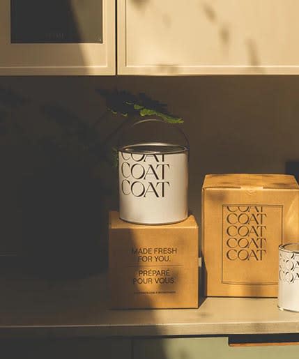three boxes and a candle on a shelf