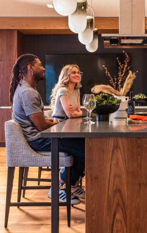 a group of people standing around a kitchen counter