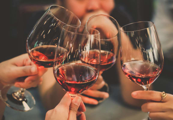 a group of people holding up wine glasses