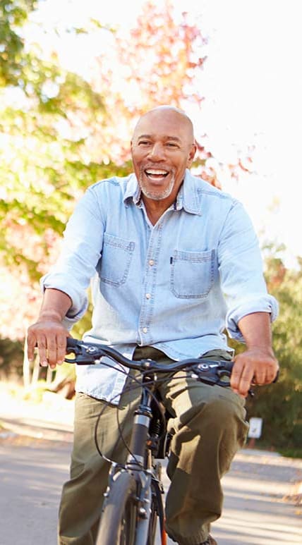 Man riding a bike at EAST PARK VILLAS Apartments, HELENA, 59601