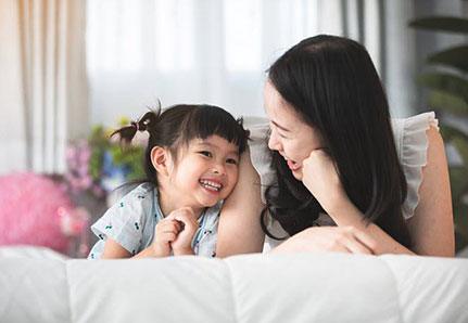 Mother and daughter smiling