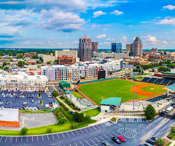 an aerial view of a city with a baseball field