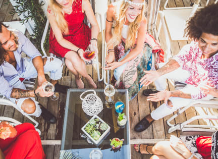 a group of people sitting around a table with drinks