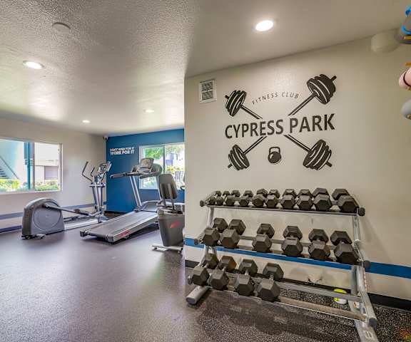 A gym with a sign that says Cypress Park Fitness Club.