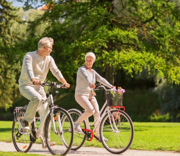 Fridley, MN Georgetown on the River |a man and a woman riding bikes in a park