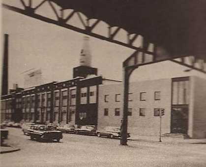 a black and white photo of a street and a building