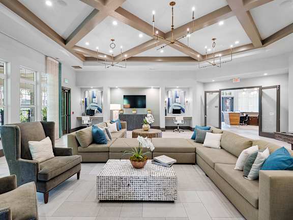 A patio with a black railing and a white couch.