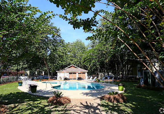 a backyard with a pool and a pool house