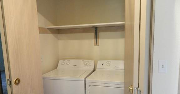 A small laundry room with a washer and dryer.